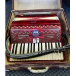 A Capri red marbled finish accordion in case.
