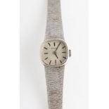 A ladies 9ct white gold cased Tissot wrist watch, the dial having hourly baton markers, inner case