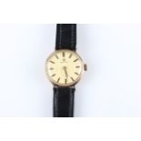 A ladies 9ct yellow gold Omega wrist watch, the gold-tone dial having hourly baton markers, inner