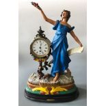 A mantel clock with indistinctly signed painted plaster of Paris figurine design, marked ‘