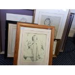 A framed, mounted, signed with initials, ink study of a seated woman holding a child in the style of