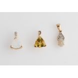 Three stone set pendants, gemstones including moonstone, opal and scapolite.