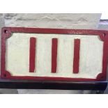 A cast iron railway sign 111 in red and cream.