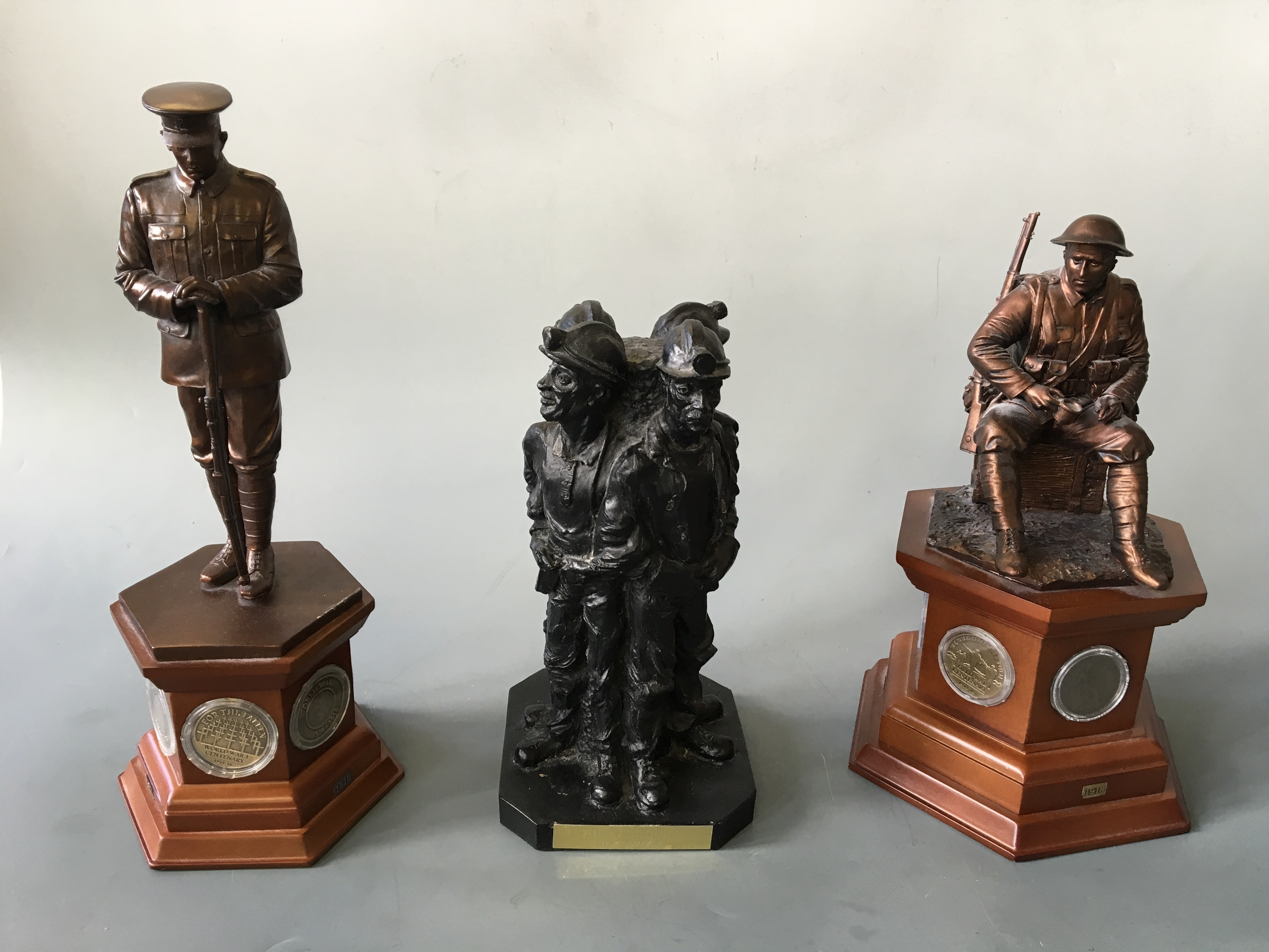 Two Danbury Mint World War One commemorative bronzed sculptures on wooden plinths with sets of WWI