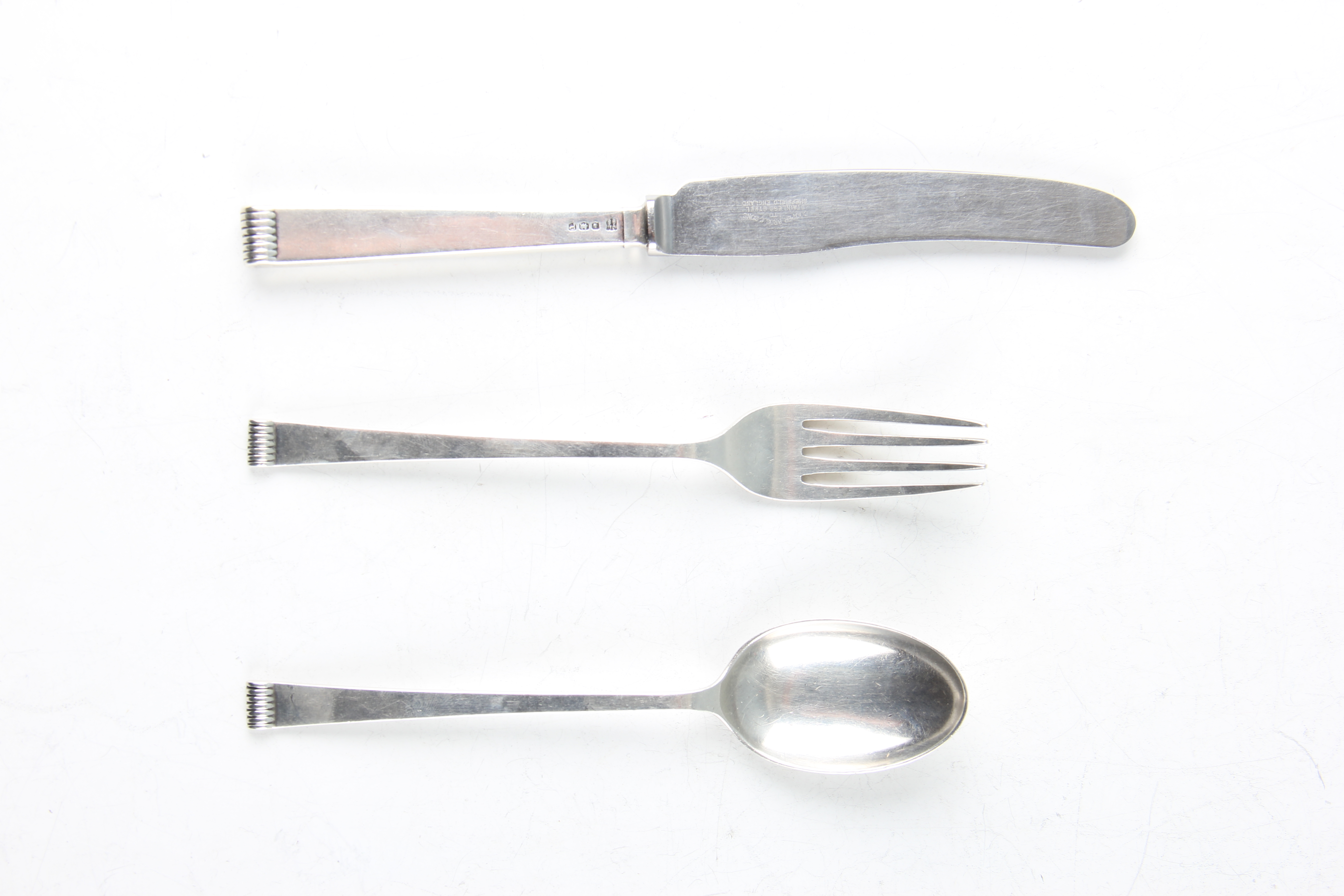 A boxed silver christening set, comprising a fork, knife and spoon, all hallmarked Sheffield 1957,