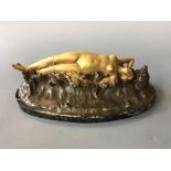 DROUARD. A signed, gilded bronze nymph lying on waves, on black and green marble base, length of