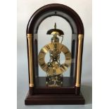 A mahogany and glass cased skeleton mantel clock, height approximately 35cm.