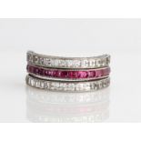 A ruby, sapphire and colourless stone 'Night & Day' full eternity ring, half of the central band