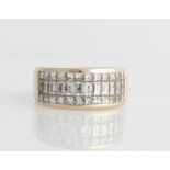 An 18ct white gold diamond half eternity ring, comprising a central row of baguette cut diamonds,