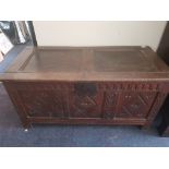 An early 19th century carved front oak coffer.