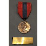 An Imperial Service medal.