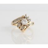 A hallmarked 14ct yellow gold diamond dress ring, set with a central round brilliant cut diamond