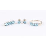 A suite of blue topaz jewellery, comprising of a pair of earrings, a four stone pendant and a