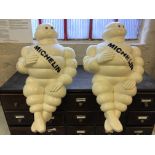 Two Michelin Man plastic advertising figures.