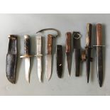 Trench knives, five with sheaths, six in total.