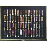 A framed collection of British Campaign and Gallantry Medals with framed Second World War Victory