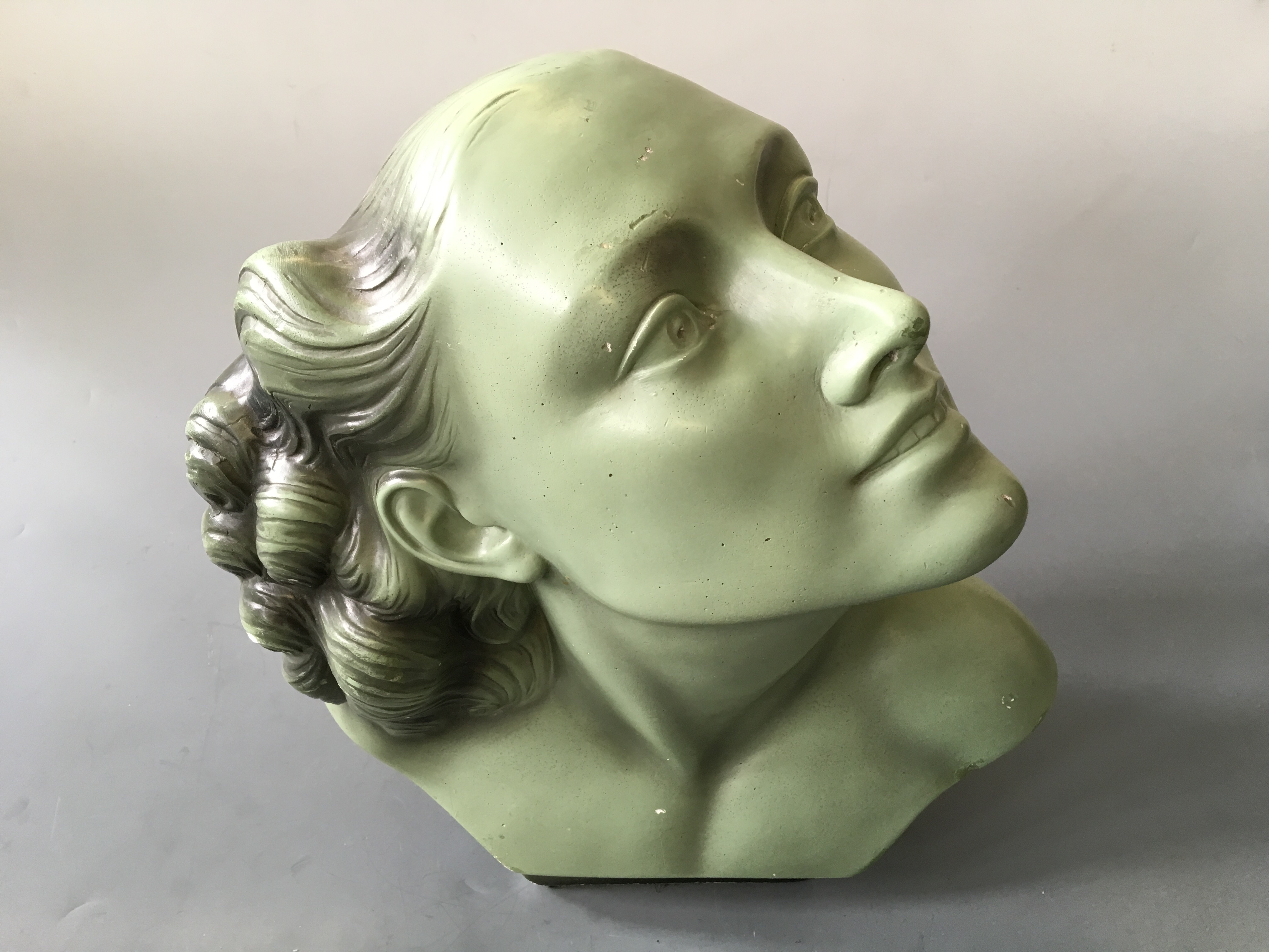 SALVATORE MELANI. An Art Deco green painted bust of female, marked 92, Deposé, height 36cm, width