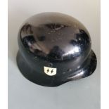 A German black painted 42 helmet with hand painted SS symbol to side.