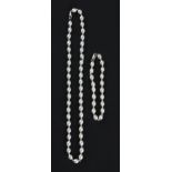 A part suite of pearl jewellery, comprising a string of pearls with white metal spacers, length