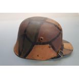 A WW1 German M-1916 helmet, painted camouflage.