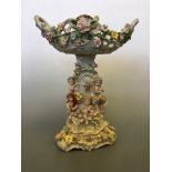 A German style porcelain centrepiece decorated with cherubs and flowers, height 47cm.