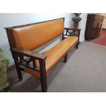 Art Deco style mahogany framed bench with tan brown leather back and seat.