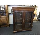 A mahogany glazed two door book case with three shelves. Height 146cm, width 121cm and depth 33.5cm