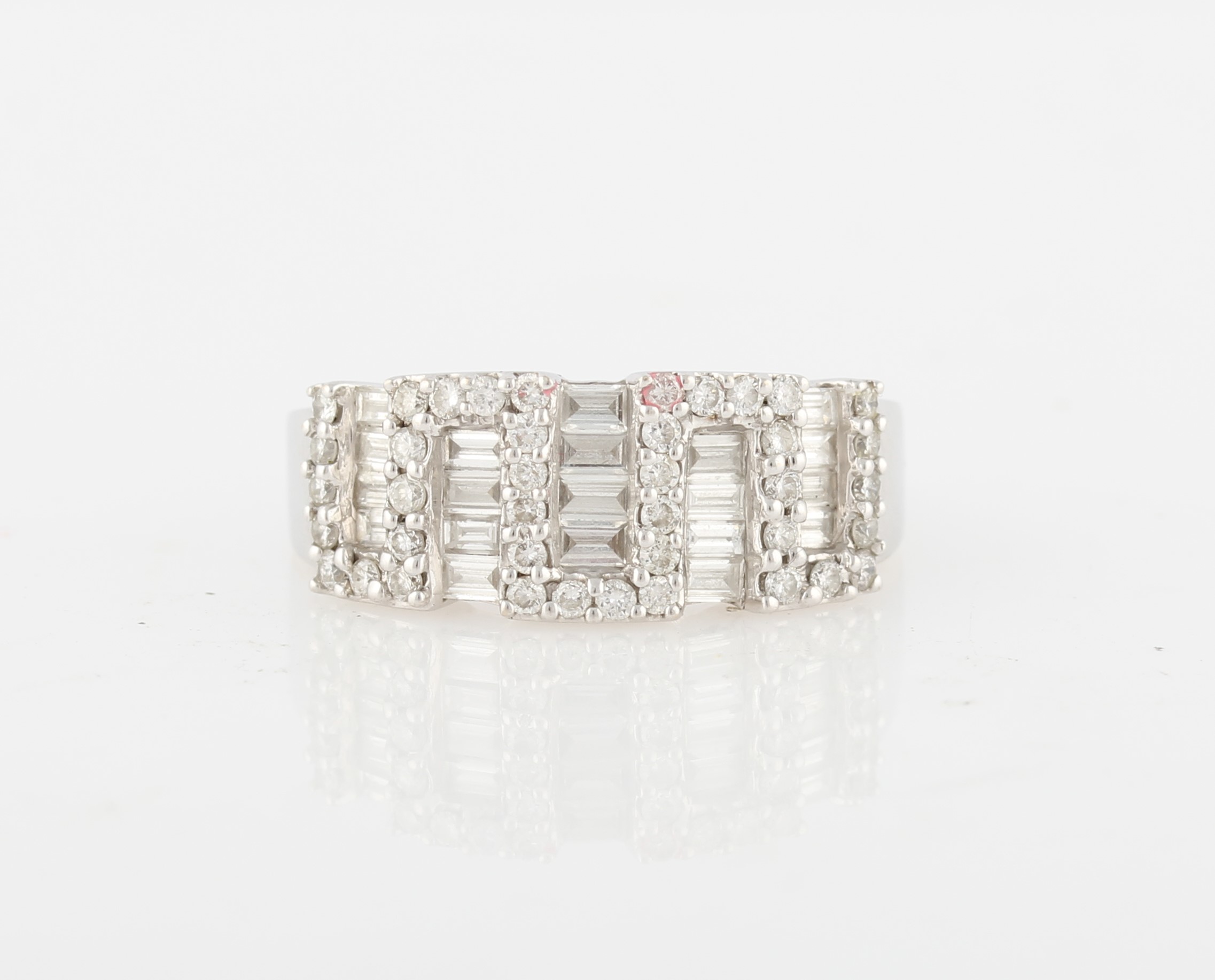 A diamond cluster ring, set with five rows of baguette cut diamonds separated by a geometric