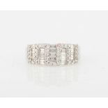 A diamond cluster ring, set with five rows of baguette cut diamonds separated by a geometric