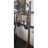 An oak framed with cast iron scroll lantern standard lamp.