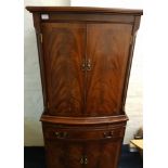 A reproduction mahogany four door single door cocktail cabinet.