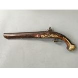 A flintlock pistol with carved and brass detail.