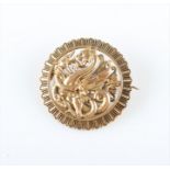 An open metalwork dragon and serpent brooch, unmarked yellow metal, diameter approx. 3cm.