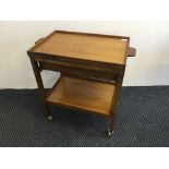 A Teak tea trolley with lift up tray.