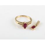 A ruby and diamond ring, set with a central marquise cut ruby with diamond accents to either side