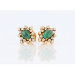 A pair of emerald and diamond cluster earrings, each set with an oval cut emerald cabochon,