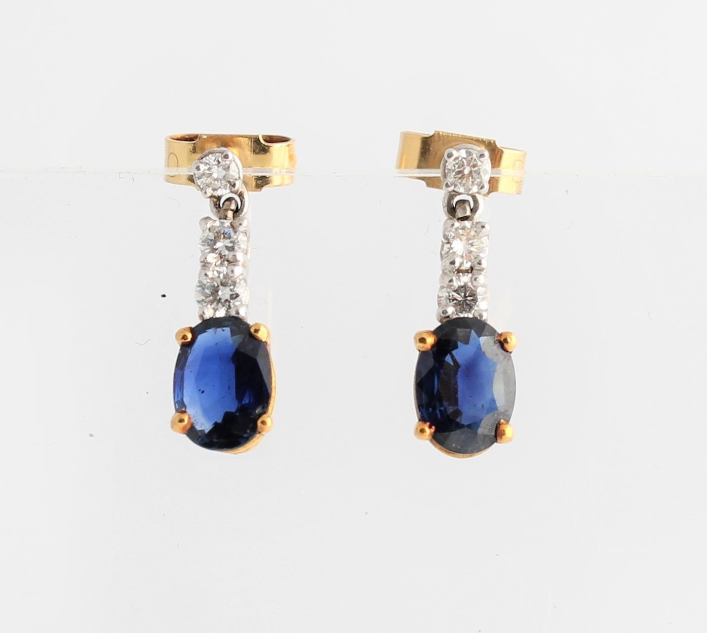 A pair of sapphire and diamond stud dropper earrings, each set with an oval cut sapphire,