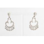 A pair of diamond chandelier earrings, the open metalwork scroll design set with round brilliant cut