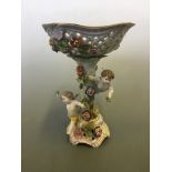 A German Tazza with pierced top and decorated with cherubs, height 32.5cm.