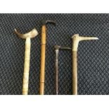 Four various walking sticks including three wooden.