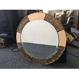 An Atsonfa Art Deco round mirror with amber glass and leaf panels to edge.