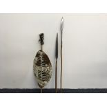 A Zulu Shield, Iklwa, spear and carved wooden items including bowl on stand, mask, spears,