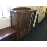 A walnut two door glazed display cabinet with two shelves. Height approximately- 127cm, width- 118c