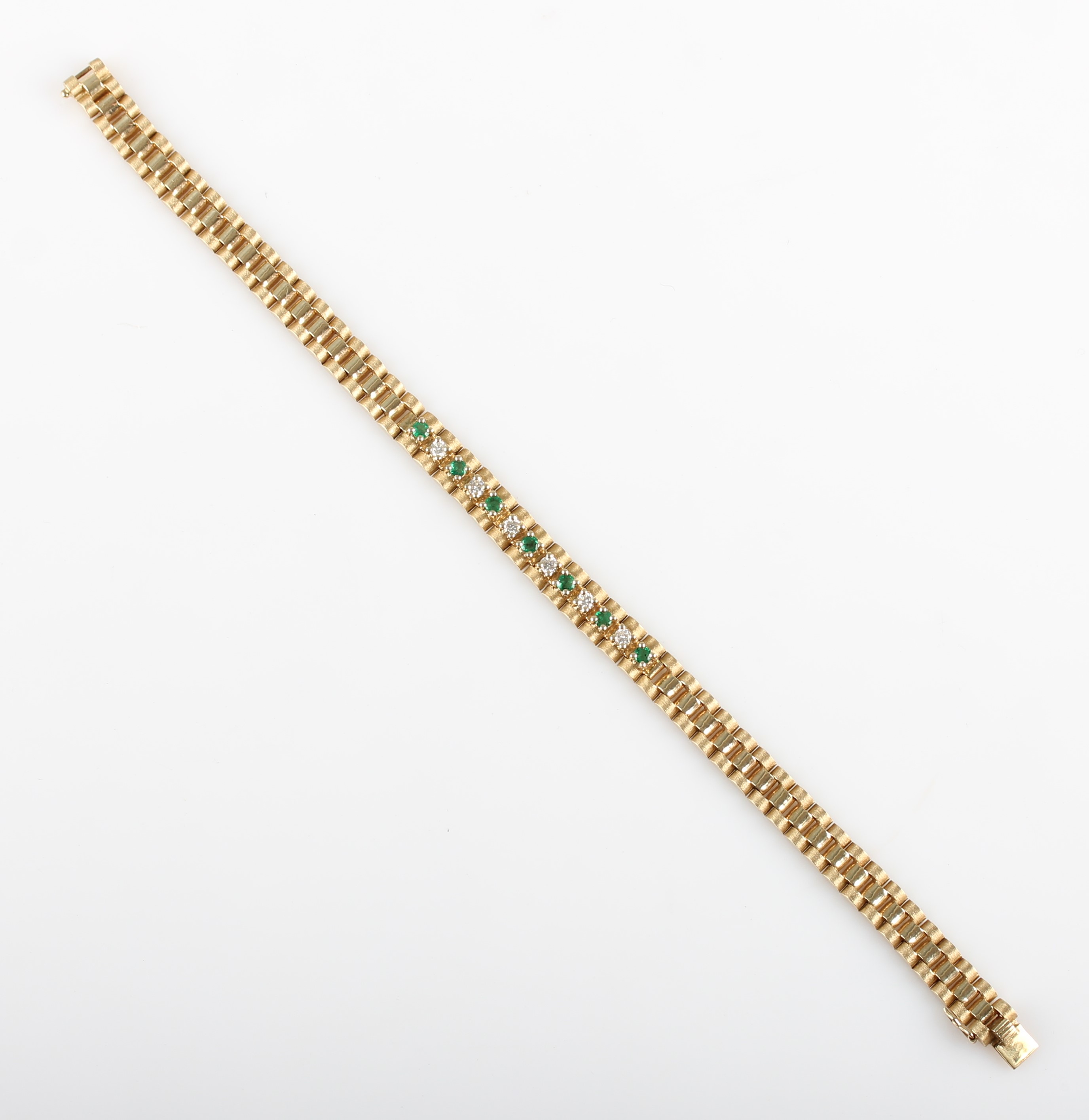 An emerald and diamond bracelet, set with seven round cut emeralds and six round brilliant cut