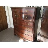 A reproduction mahogany eight drawer chest.
