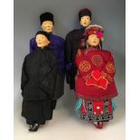 Four early 20th Century Door of Hope Mission dolls, with carved wooden faces and dressed in silk,