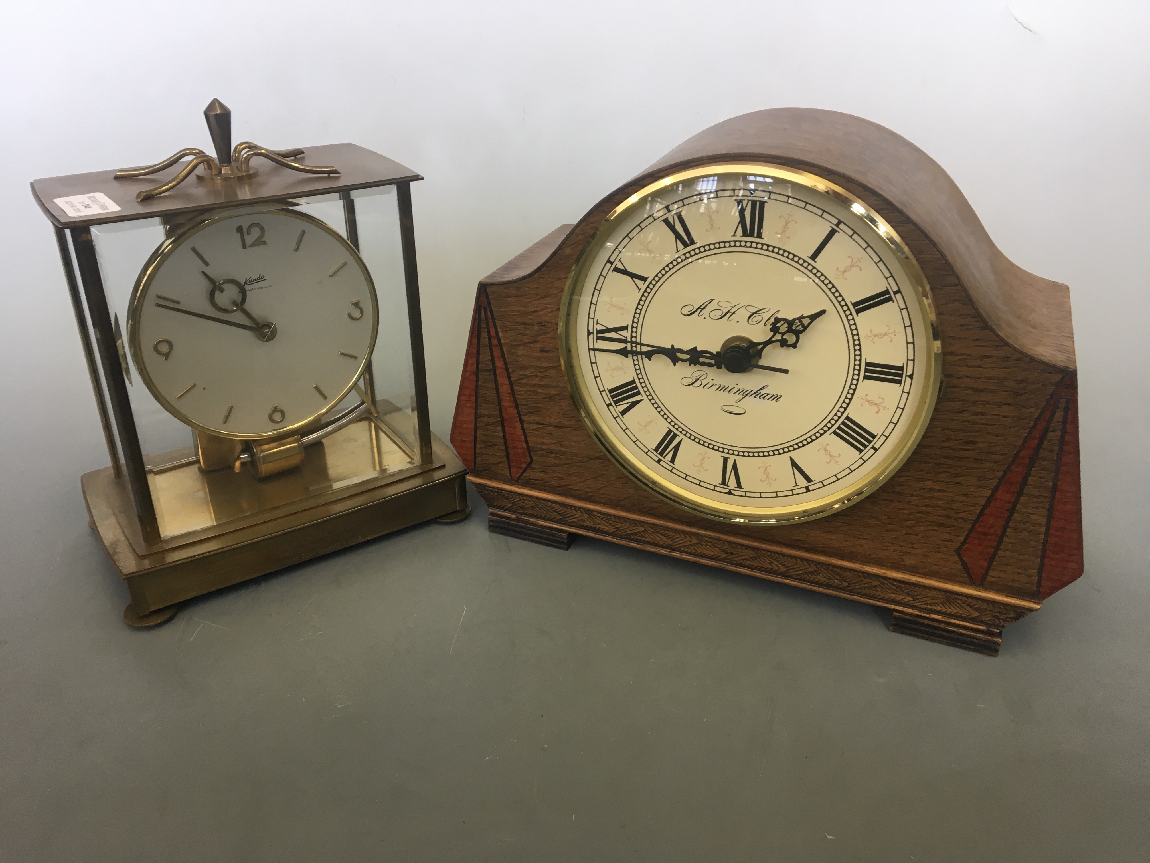 An A.H. Clarke Birmingham mantel clock with Kundo electronic mantel clock.