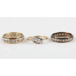 A collection of rings, to include a three stone diamond cross over design ring, stamped 9ct PLAT,