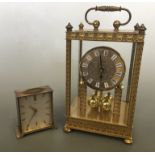 An anniversary clock and a Smiths eight day table clock, both brass finished.