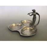 Pewter tray with female figure and leaf design.